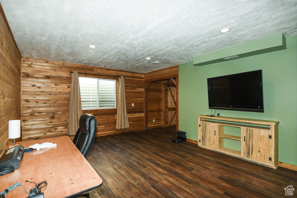 Unfurnished office with wood finished floors, recessed lighting, wooden walls, and baseboards