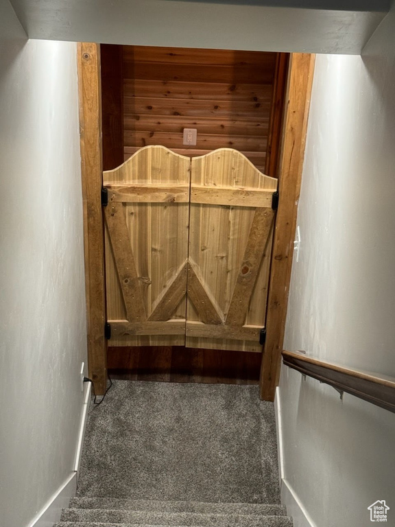 Staircase featuring carpet floors and baseboards