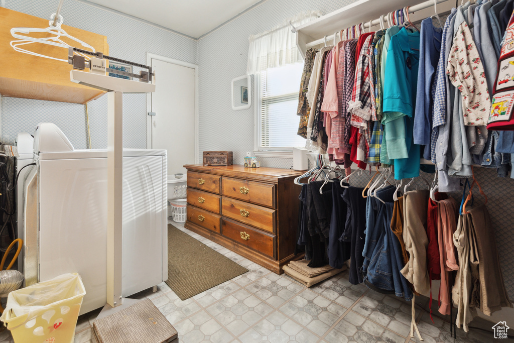 Walk in closet featuring light flooring and washer and dryer