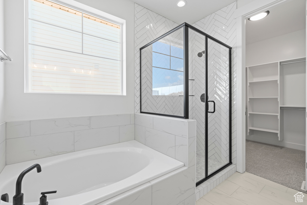Full bathroom with a bath, a stall shower, marble finish floors, recessed lighting, and a spacious closet