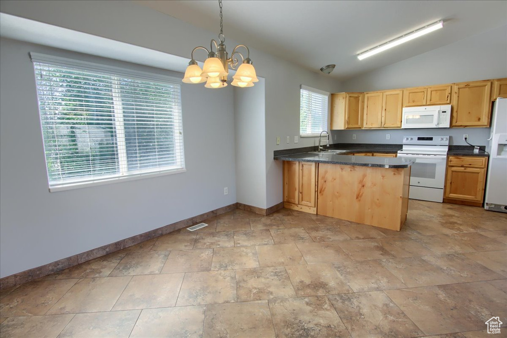 Kitchen featuring white appliances, a sink, baseboards, dark countertops, and a chandelier