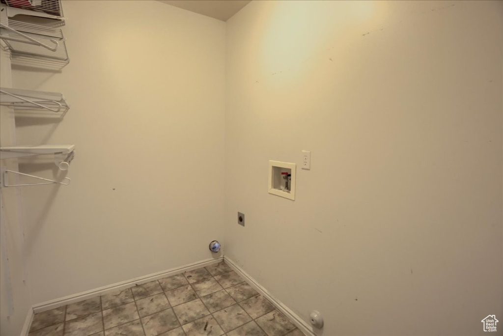 Laundry area with hookup for a washing machine, baseboards, electric dryer hookup, and gas dryer hookup