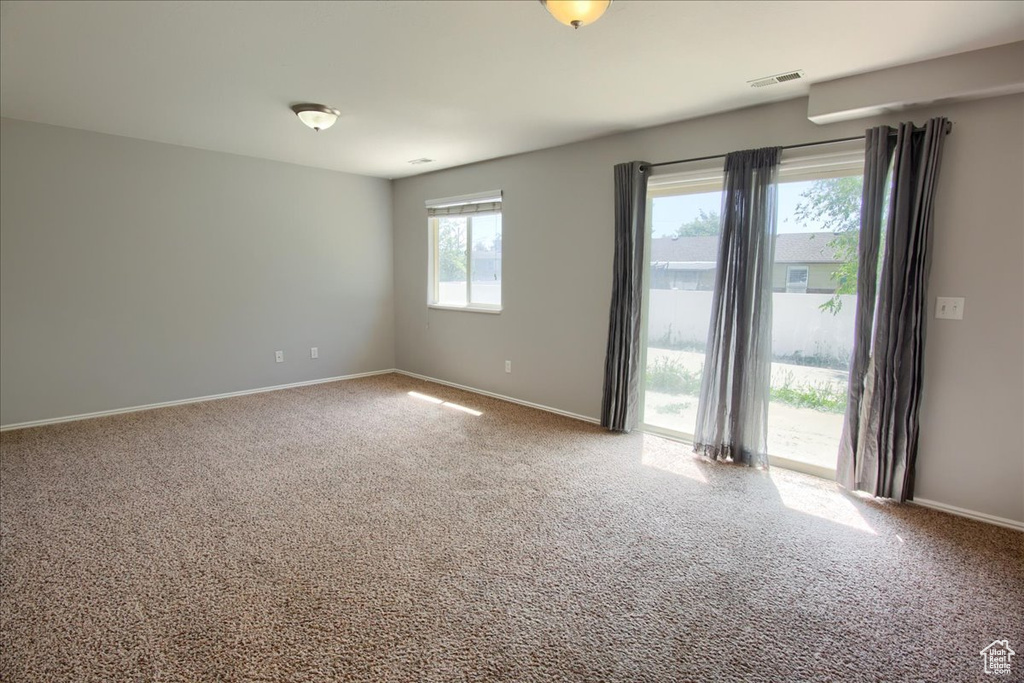 Carpeted empty room with baseboards