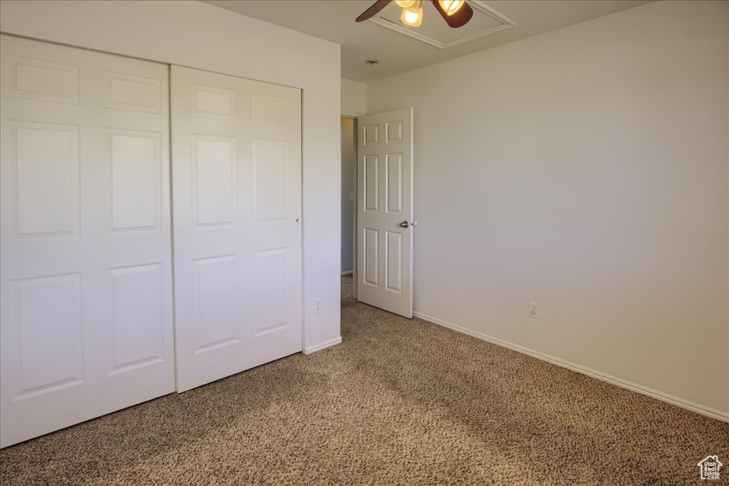 Unfurnished bedroom with light carpet, a closet, baseboards, and ceiling fan