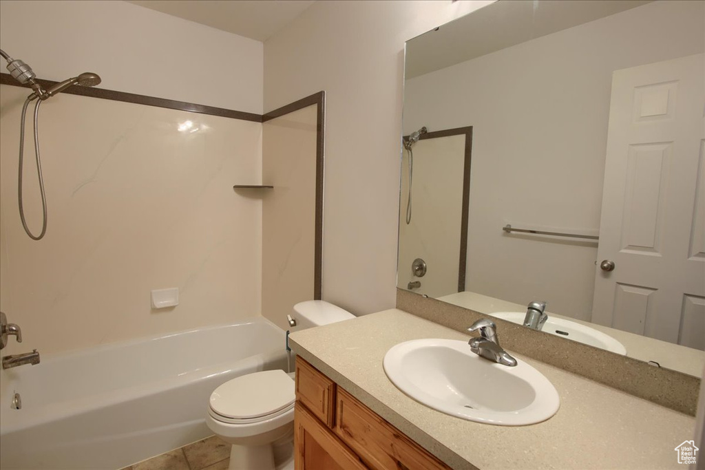 Bathroom featuring vanity, toilet, shower / tub combination, and tile patterned floors