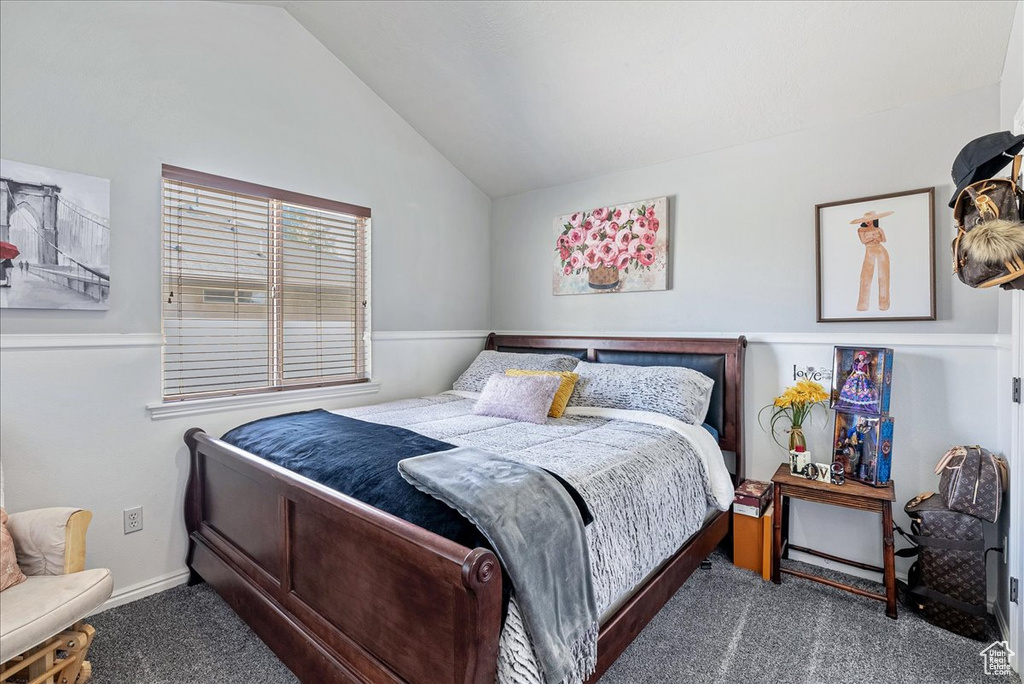 Bedroom featuring carpet floors and vaulted ceiling
