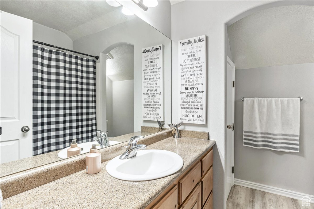 Bathroom with vanity and wood finished floors