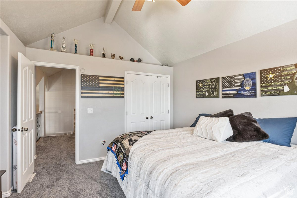 Carpeted bedroom featuring beamed ceiling, a closet, high vaulted ceiling, a ceiling fan, and baseboards