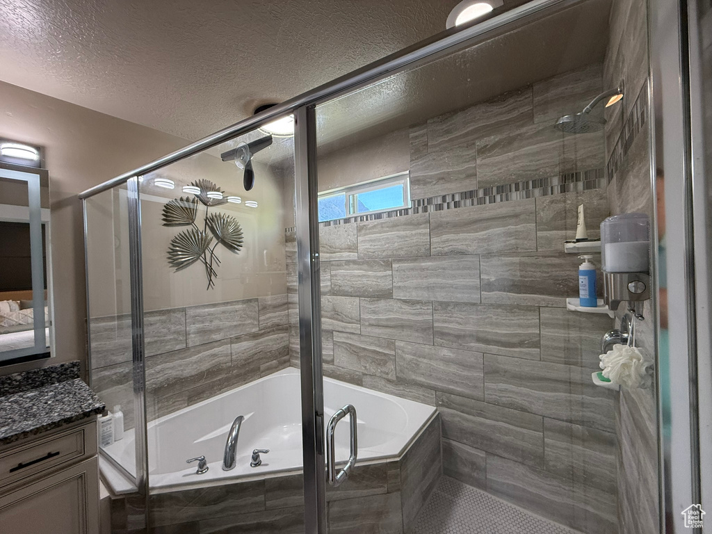 Full bathroom featuring vanity and a textured ceiling