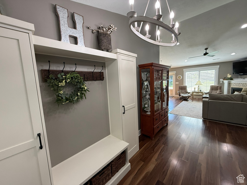 Mudroom with ceiling fan, dark wood-style floors, a chandelier, a fireplace, and recessed lighting