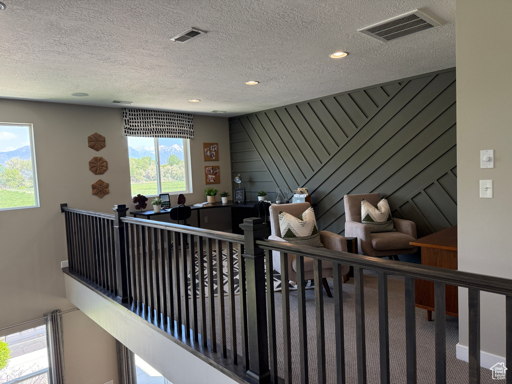 Hall featuring a textured ceiling and recessed lighting