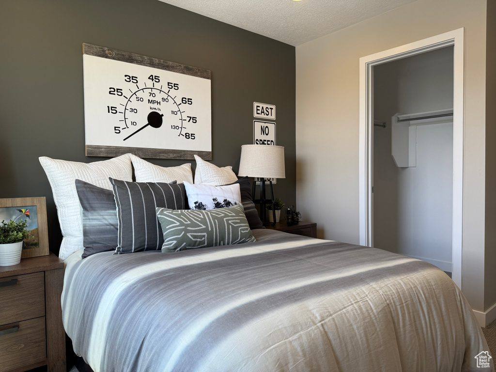 Bedroom featuring a textured ceiling