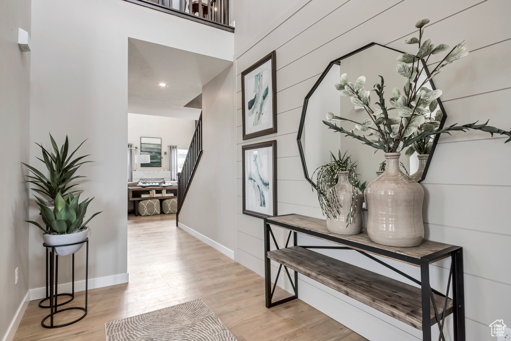 Hallway with light wood-style flooring and baseboards