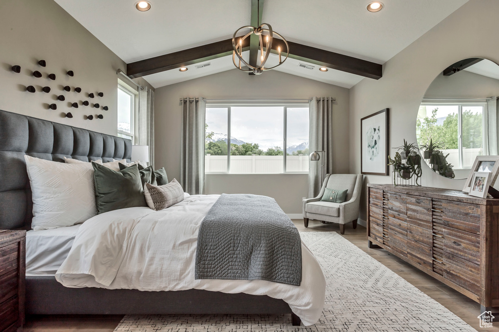 Bedroom with recessed lighting, arched walkways, a chandelier, wood finished floors, and baseboards