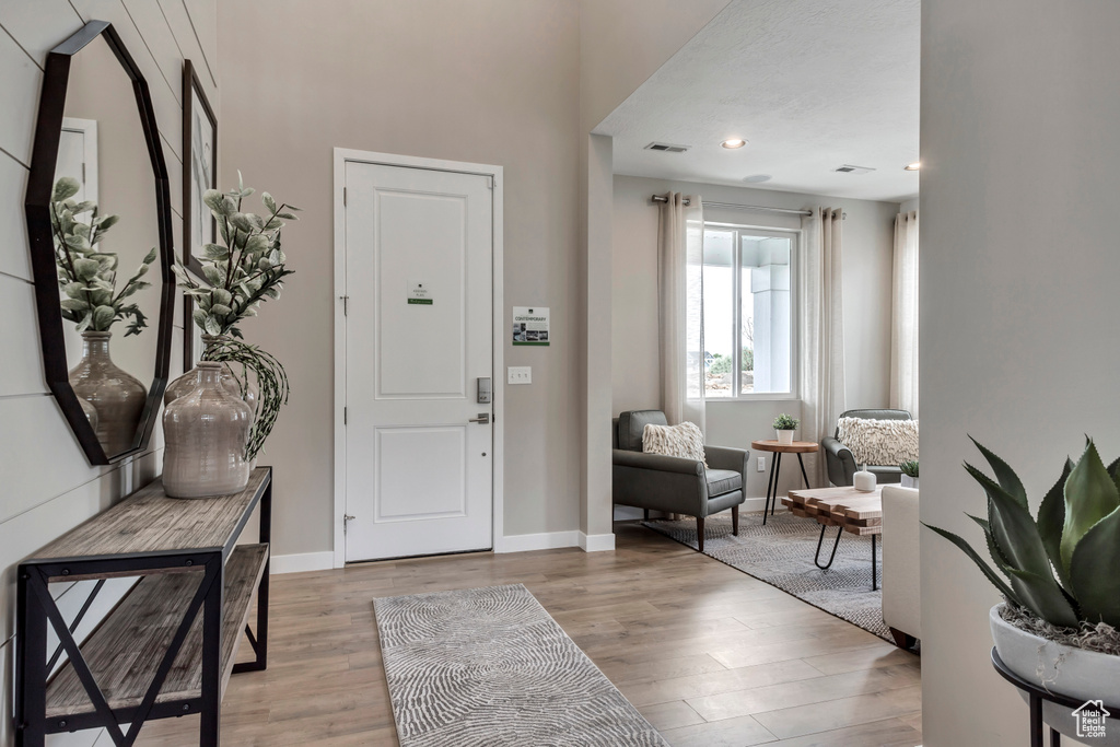 Entrance foyer with light wood-type flooring and baseboards