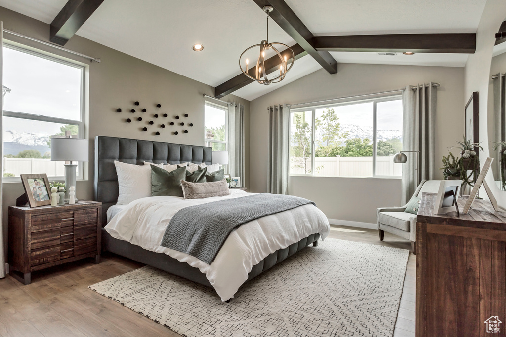 Bedroom with light wood-type flooring, a chandelier, multiple windows, and recessed lighting