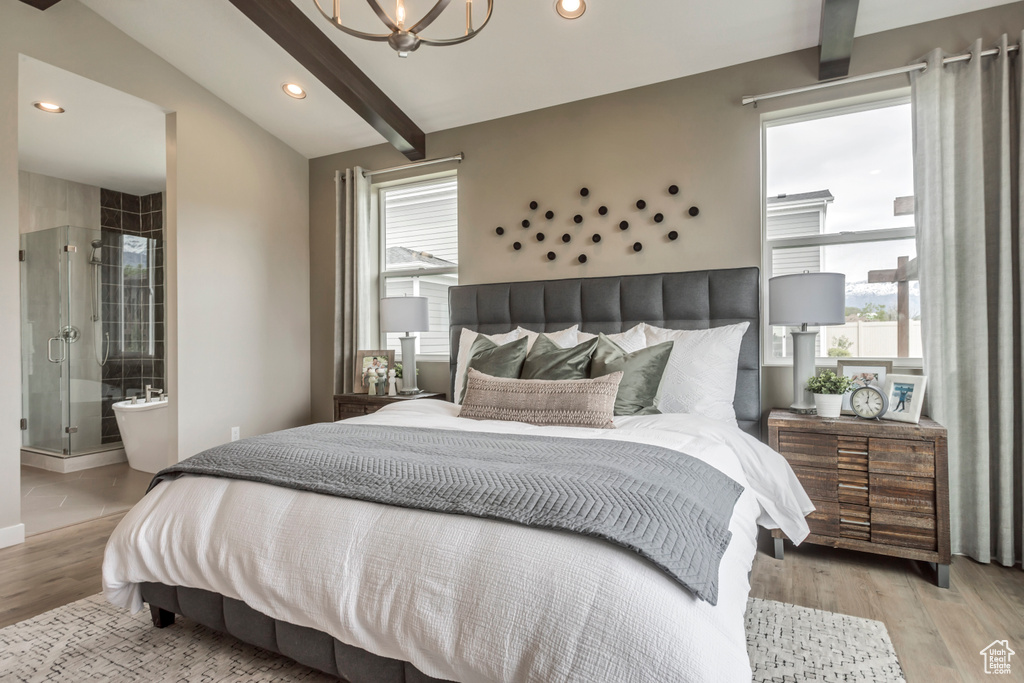 Bedroom featuring multiple windows, a chandelier, wood finished floors, recessed lighting, and connected bathroom