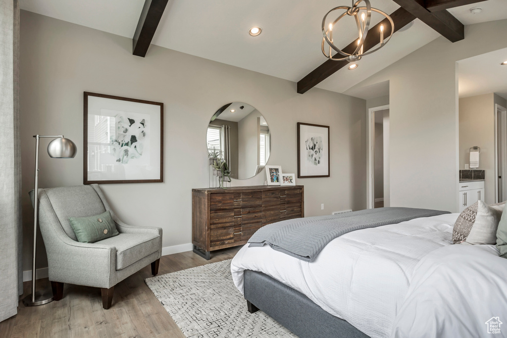 Bedroom with a chandelier, wood finished floors, recessed lighting, ensuite bath, and baseboards