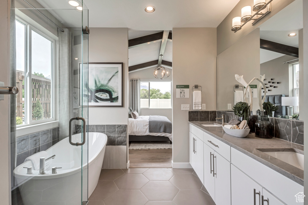 Full bathroom with double vanity, tile patterned flooring, a soaking tub, ensuite bath, and recessed lighting