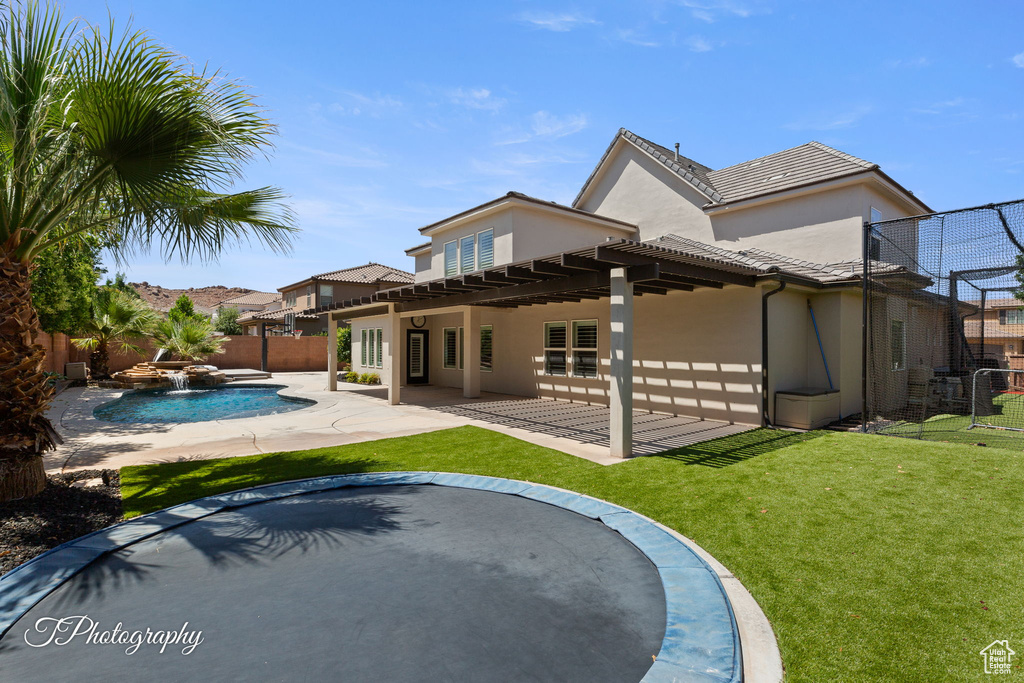 Rear view of house with stucco siding, a patio, and a tiled roof