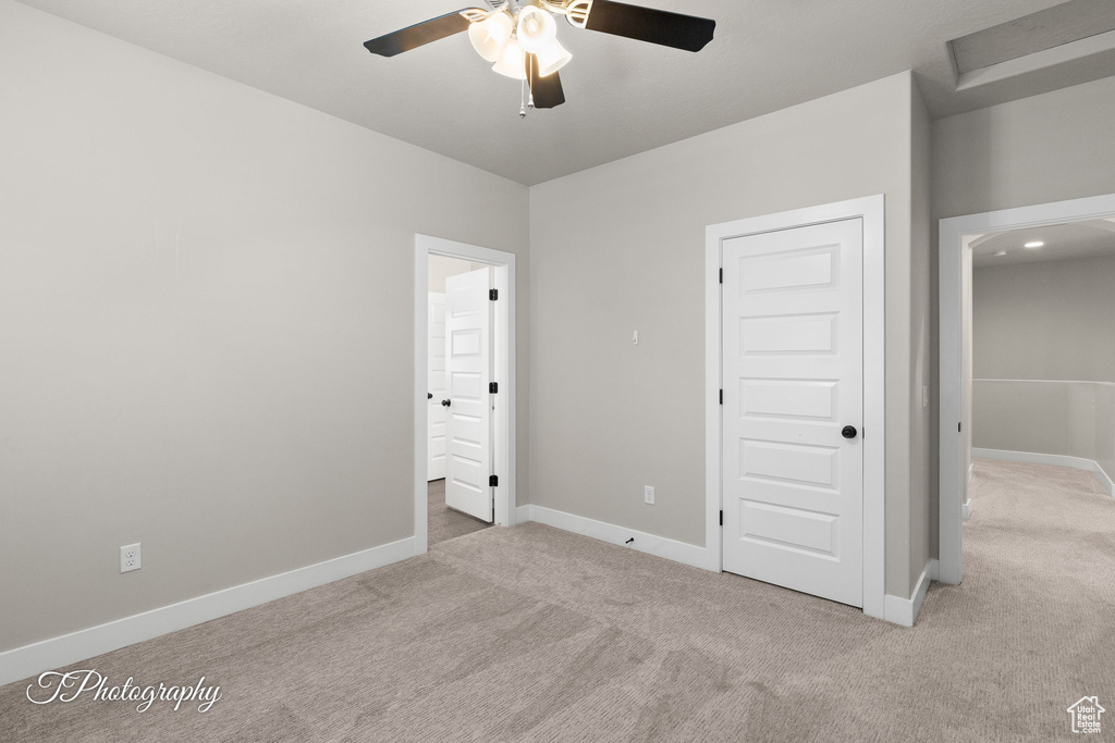 Unfurnished bedroom featuring carpet flooring, baseboards, and connected bathroom