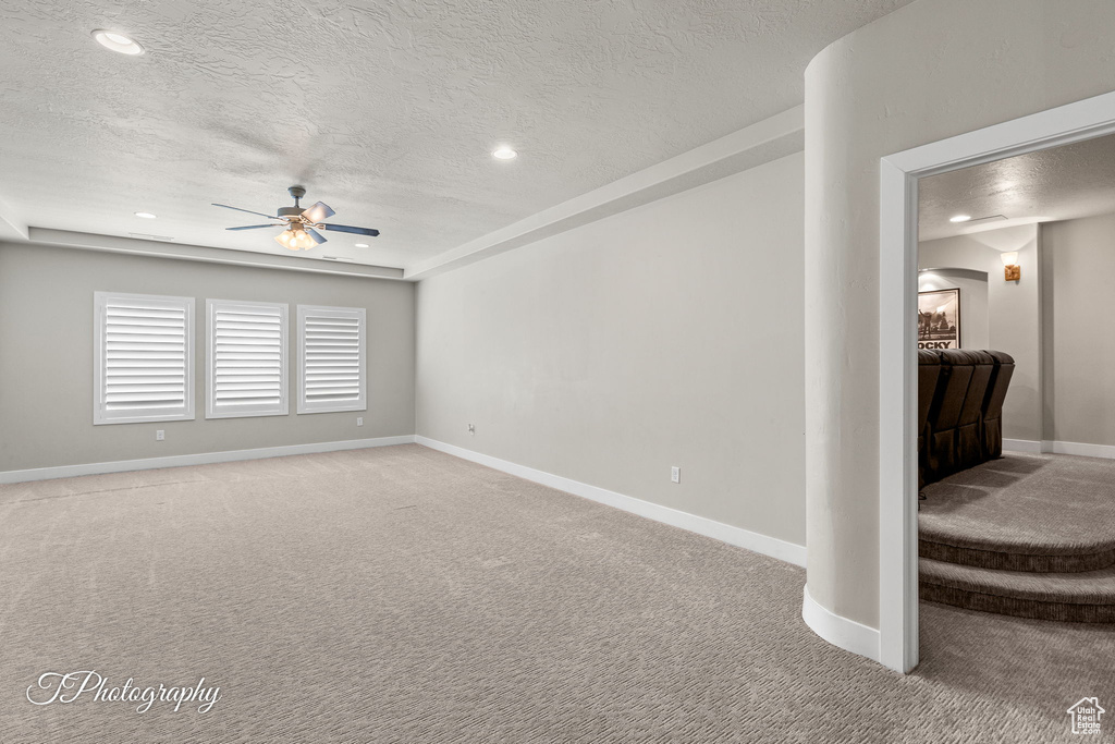 Unfurnished room with a ceiling fan, light carpet, a textured ceiling, baseboards, and recessed lighting