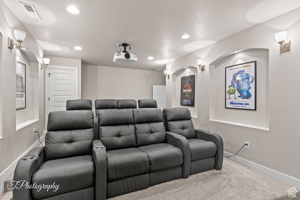 Cinema featuring carpet flooring, recessed lighting, baseboards, and a textured ceiling