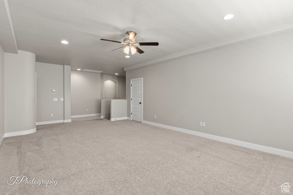 Spare room featuring a ceiling fan, recessed lighting, light carpet, and baseboards