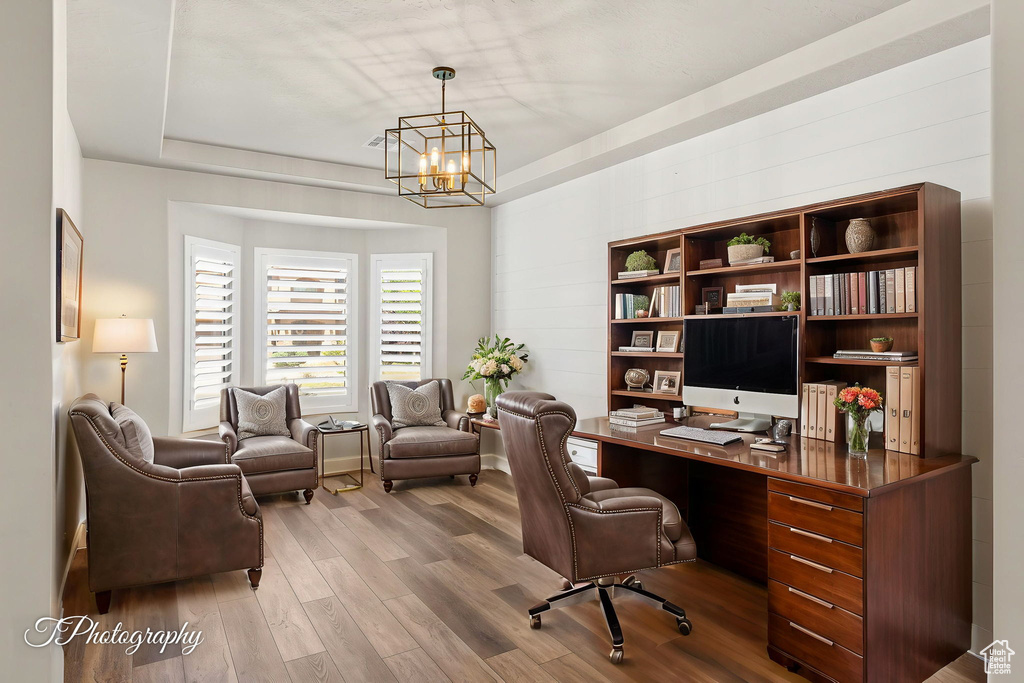 Office featuring wood finished floors and a chandelier