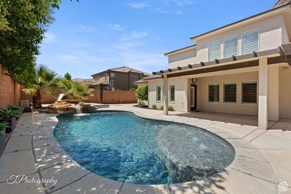 View of pool with a fenced backyard and a patio