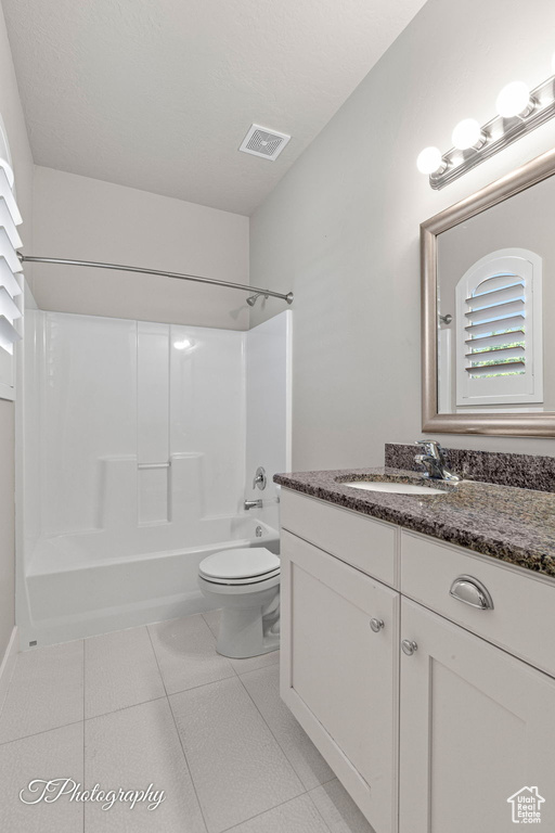 Full bath with vanity, bathtub / shower combination, toilet, and tile patterned floors