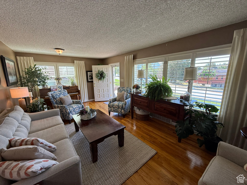 Living area featuring a textured ceiling and light wood-type flooring