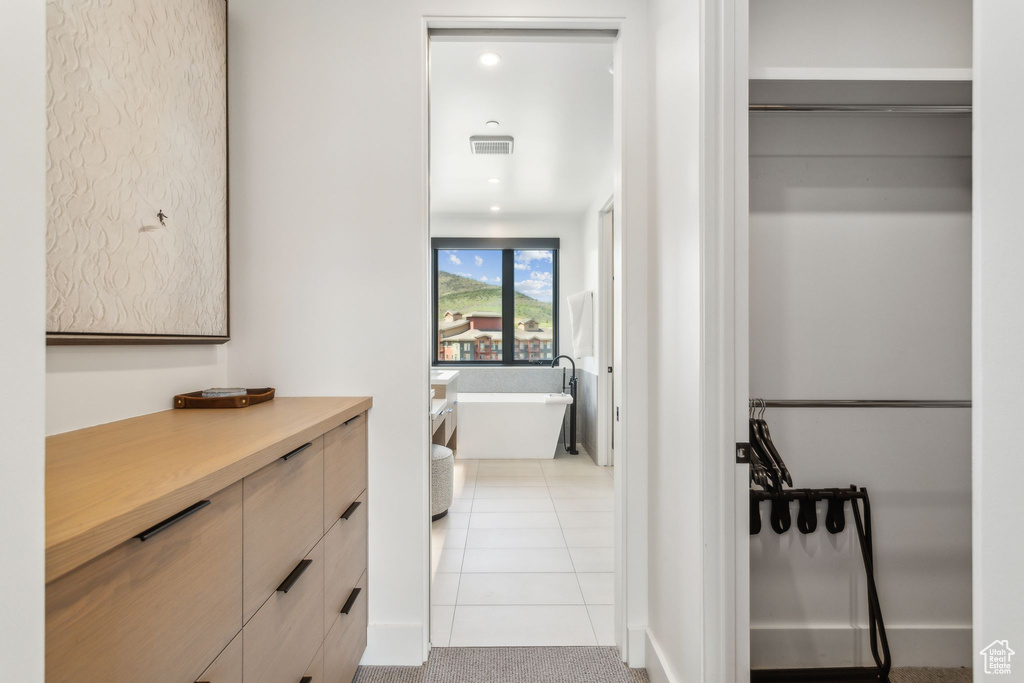 Hall featuring light tile patterned floors