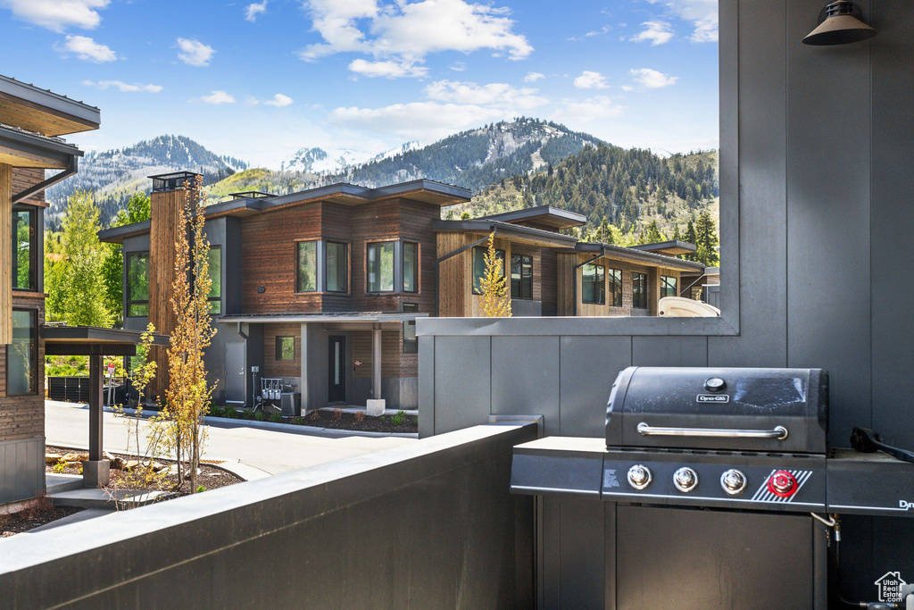 Balcony with a mountain view and area for grilling