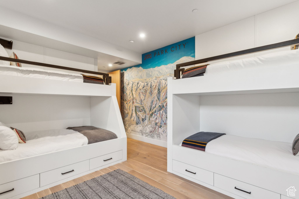 Bedroom with light wood-type flooring, baseboards, and recessed lighting
