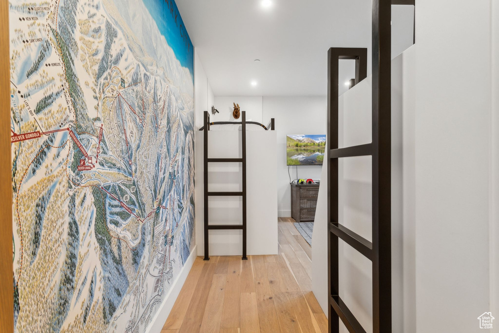 Hallway with hardwood / wood-style flooring and recessed lighting