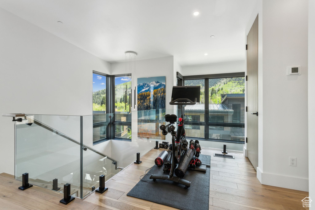 Workout area with plenty of natural light, hardwood / wood-style flooring, recessed lighting, and baseboards