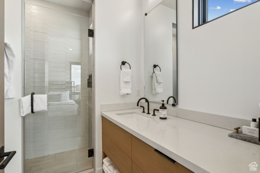 Full bathroom with vanity and a shower stall