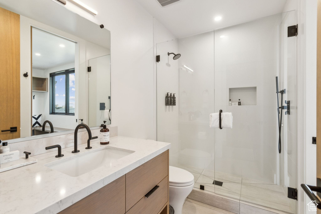 Full bath featuring toilet, a stall shower, vanity, recessed lighting, and tile patterned flooring