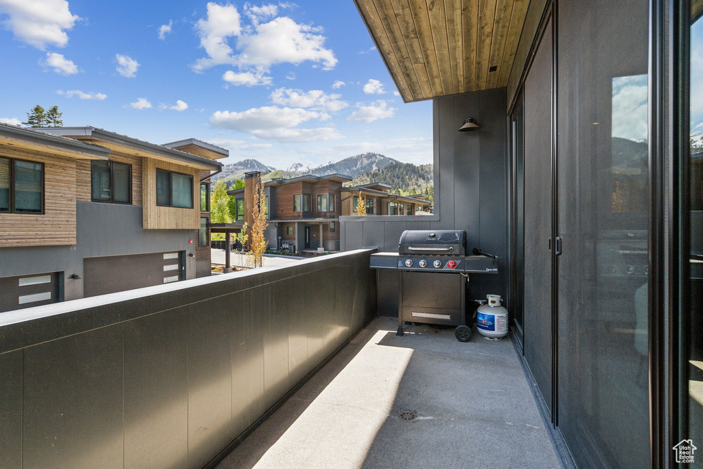 Balcony with a mountain view, grilling area, and a residential view