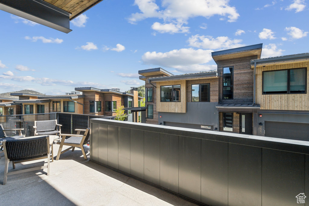 View of patio featuring a balcony and a residential view