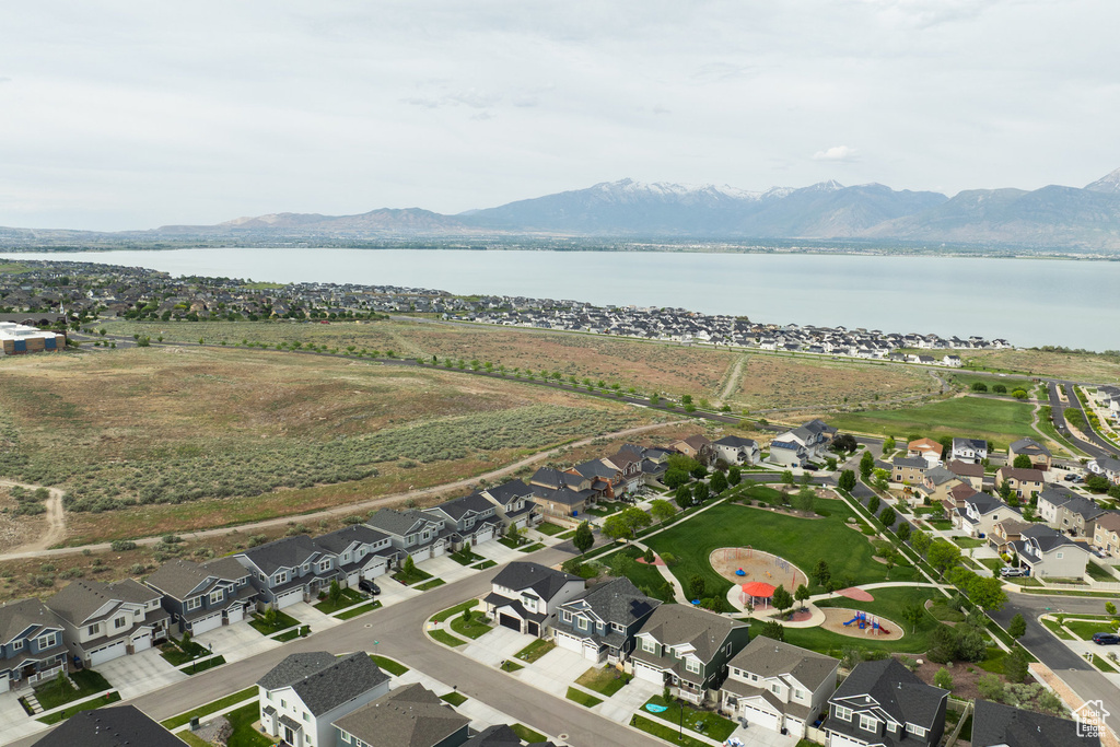 Aerial view of property's location featuring a water and mountain view and nearby suburban area