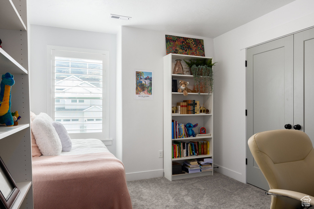 Sitting room featuring carpet and baseboards