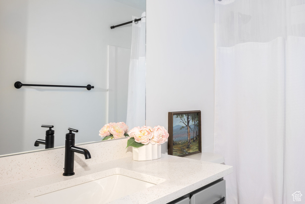 Bathroom with vanity and curtained shower