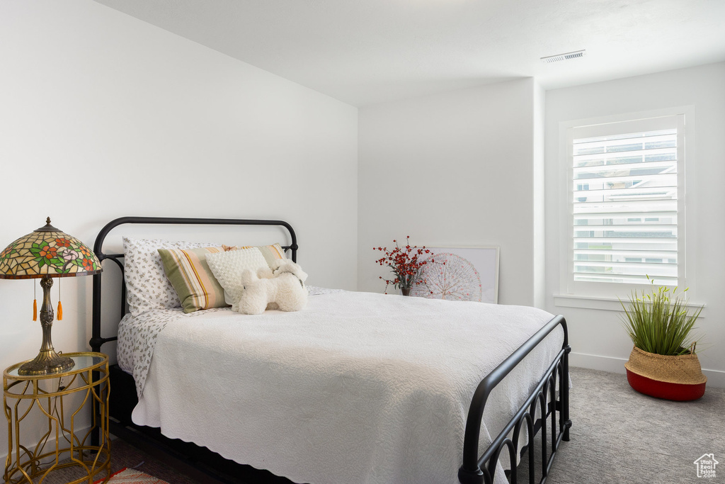 Carpeted bedroom featuring baseboards