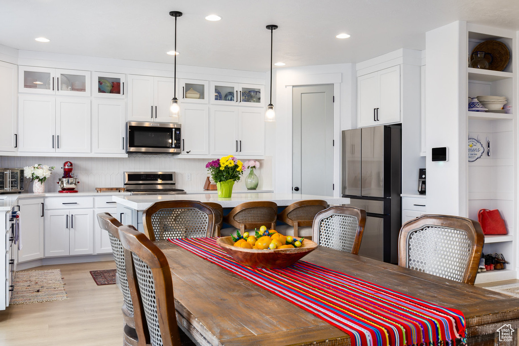 Dining room featuring light wood-style flooring and recessed lighting