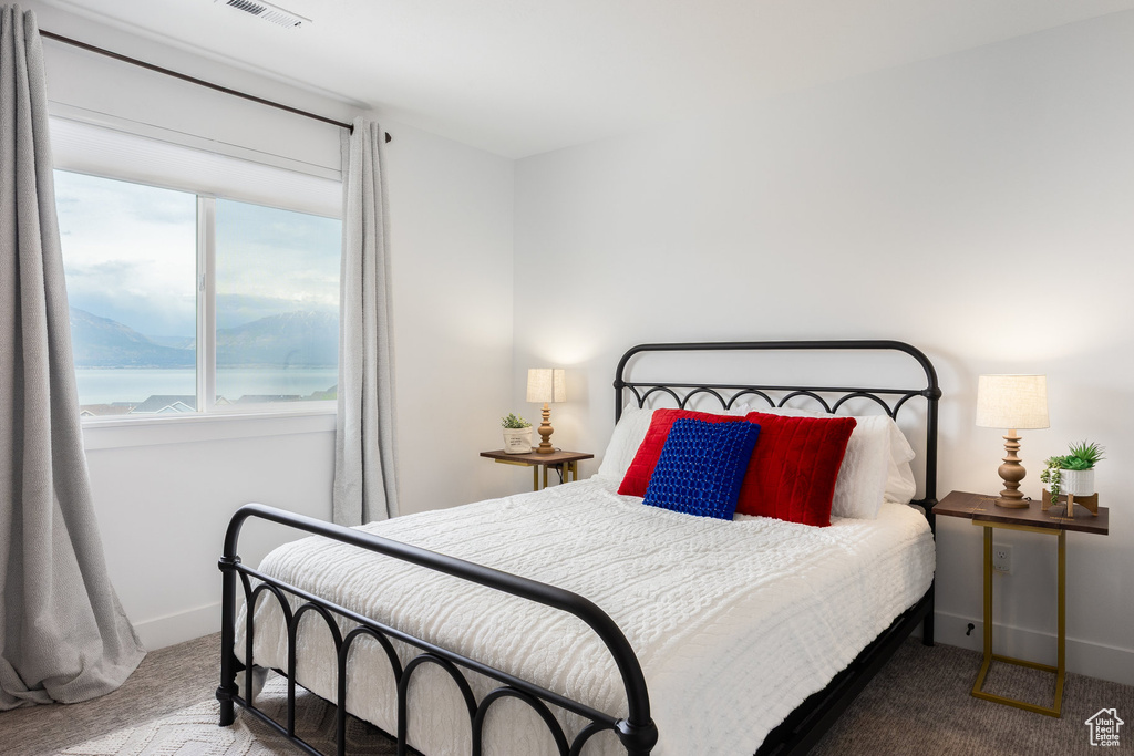 Bedroom featuring carpet floors and baseboards