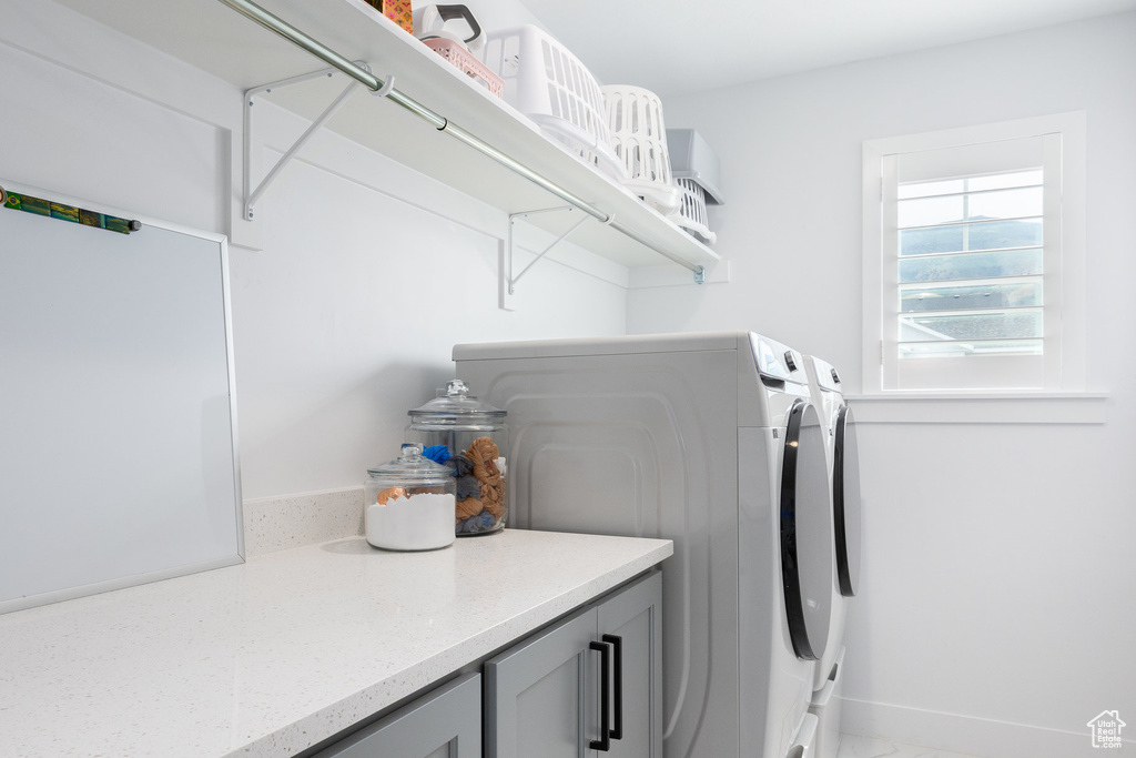 Laundry room featuring independent washer and dryer and baseboards