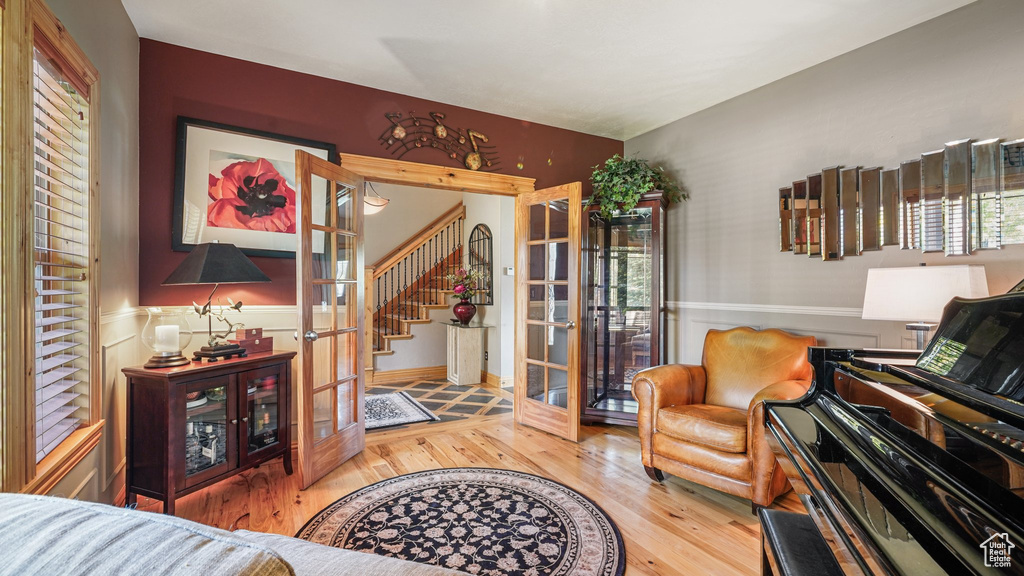 Living room featuring french doors, wood finished floors, and stairs