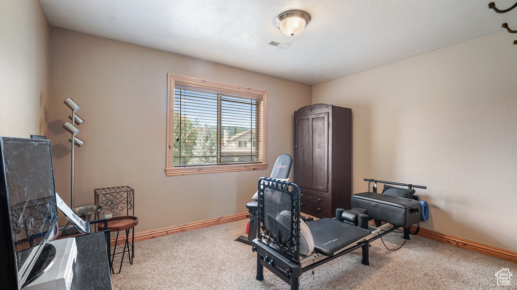 Living area with carpet flooring and baseboards